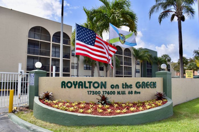 Royalton on The Green Exterior | Front sign | Flags | Building seen in background