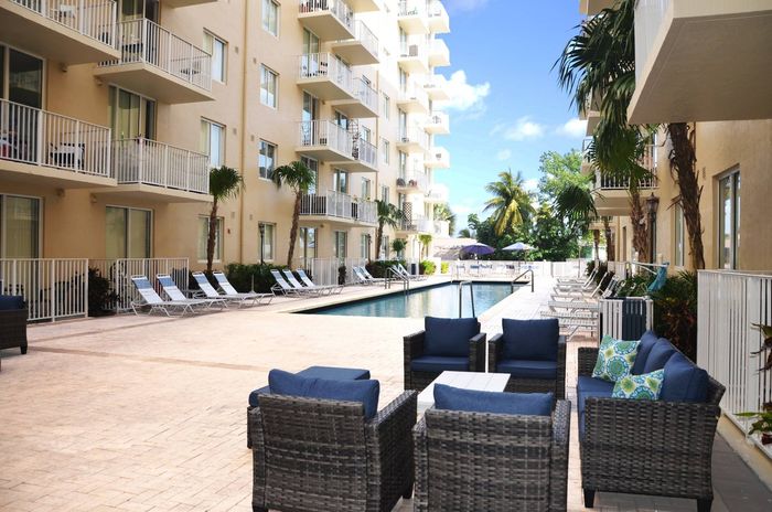Miami Riverfront Residences, exterior, swimming pool, picnic table with umbrella, balconies, lounge chairs