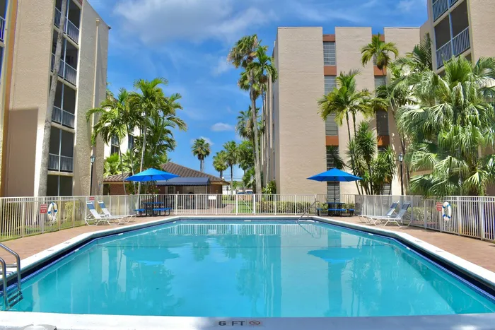 Westland 49 Apartments Exterior | Outdoor pool | Playground behind pool | Palm trees