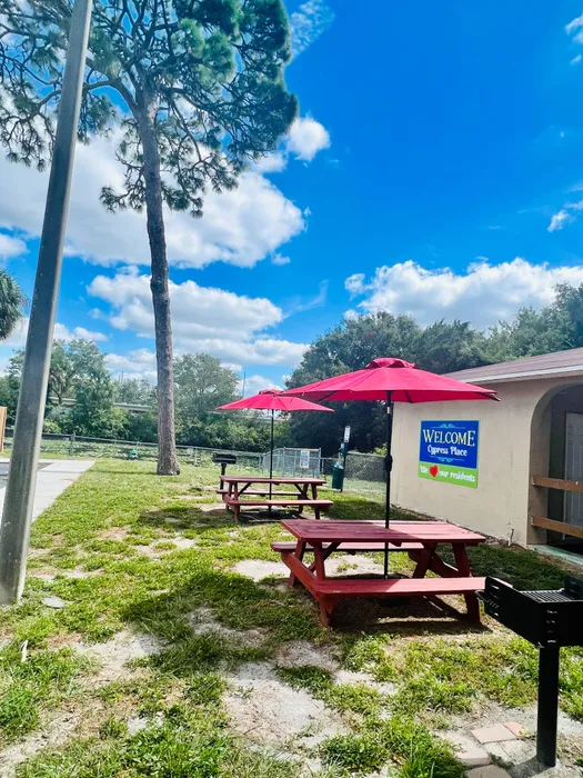 Cypress Place Apartments, exterior, outdoor gills, picnic tables with umbrellas, trees
