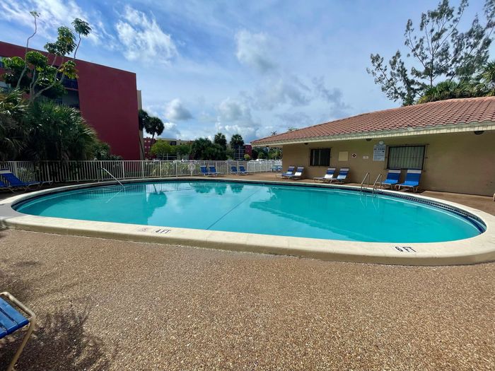 2500 Inverrary Club Apartments, exterior, buildings, sparkling blue pool, trees