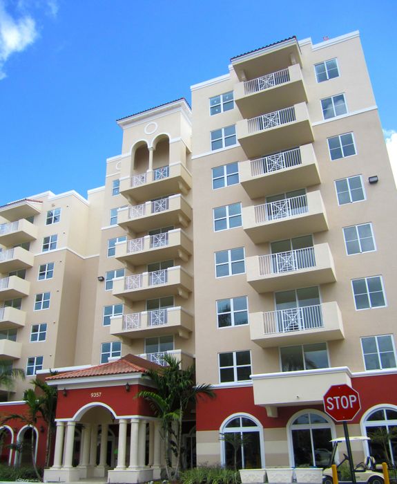 Colony at Dadeland Exterior | Beige building | Balconies | Entrance to building with arch