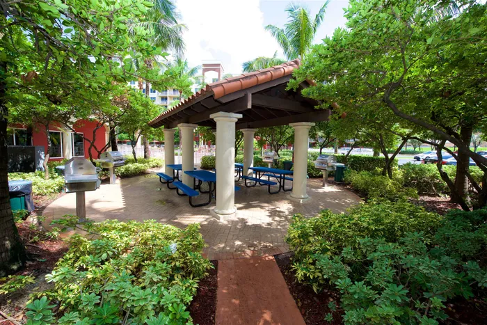 Royal Palms Apartments, exterior, pavilion, blue picnic tables, trees, shade, grill