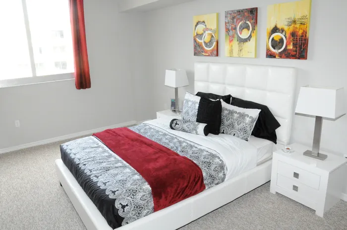 Royal Palms Apartments, interior, bedroom, carpet, bed, night stand, large window