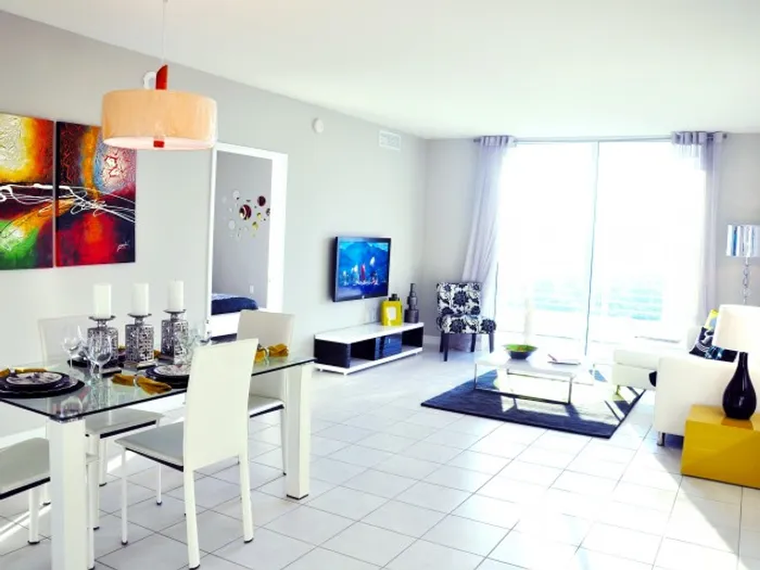 Stadium Tower Interior | Living Room | Table set | TV | Couch | Coffee Table | Balcony sliding door