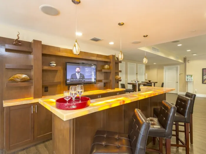 Colony at Dadeland Interior | Clubhouse | Bar area | Wine glasses on counter | TV behind the bar
