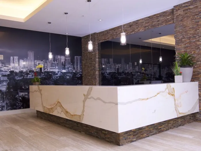 Brickell West City Rentals Interior | Lobby | Concierge Desk | City wallpaper | Mirror on side wall, behind the counter
