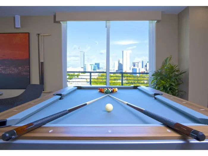 Brickell West City Rentals Interior | Clubhouse area | Pool table | Billiards | Window showing city in background