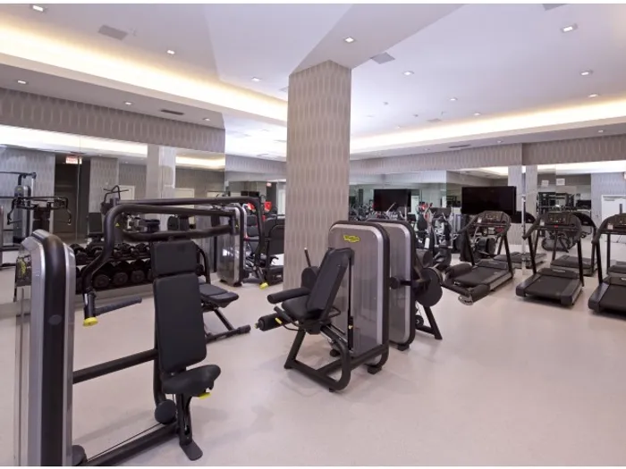 Brickell West City Rentals Interior | Fitness center | Several pieces of workout equipment | Mirror along the wall