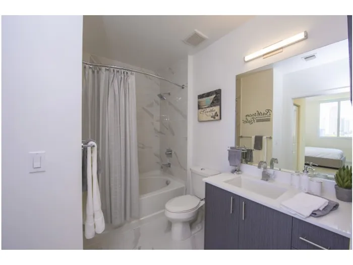 Brickell West City Rentals Interior | Bathroom | Large mirror over sink | Bathtub and shower