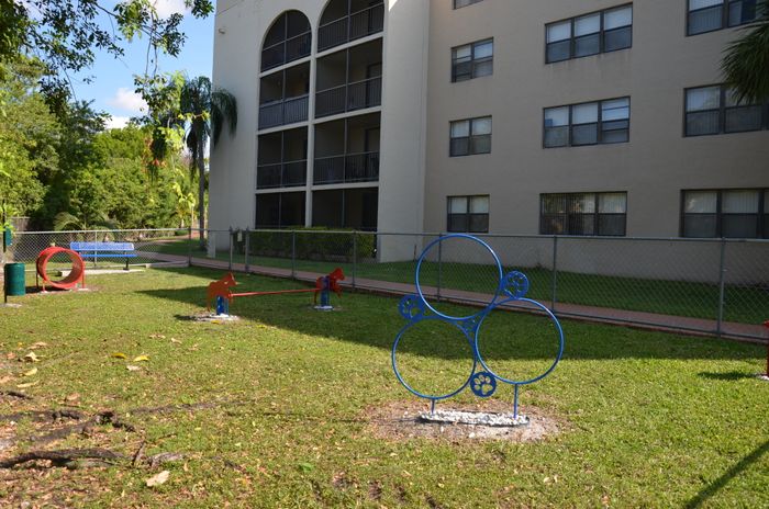 Royalton on The Green Exterior | Dog park | Gated area | Building next to park