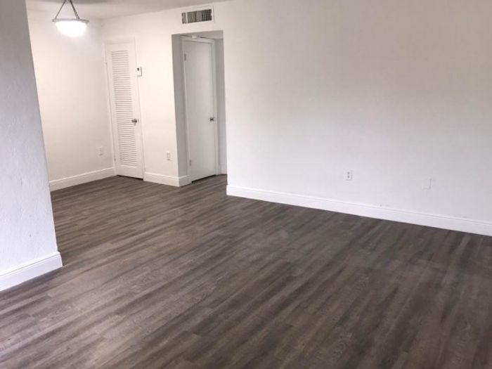 Las Brisas Gardens Apartments, interior, spacious living room, wood floor
