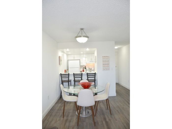 Westland 49 Apartments Interior | Dining Area | Table and chairs | Kitchen in background