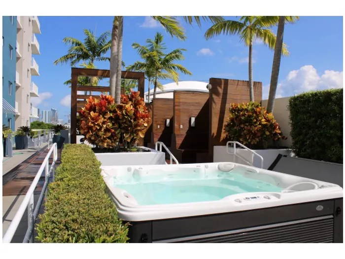 Stadium Tower Exterior | Outdoor Jacuzzi | Palm trees | Bushes on each side