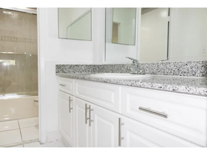 Royalton on The Green Interior | Bathroom | Sink separated from rest of bathroom by doorway | Toilet and bathtub/shower in other room