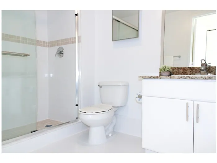 Stadium Tower Interior | Bathroom | Granite Countertops | Shower | Glass Enclosure