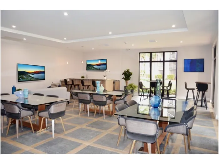 Aventura Harbor Apartments, Clubhouse to Entertain Guests, various tables, window view to exterior, bar, several tvs