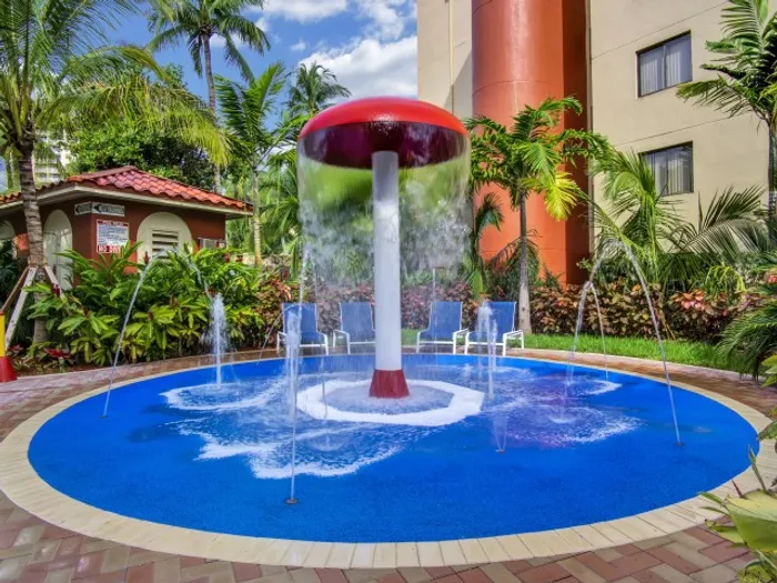 Fontainebleau Milton Apartments, exterior, children's splash pad and water fall, palm trees