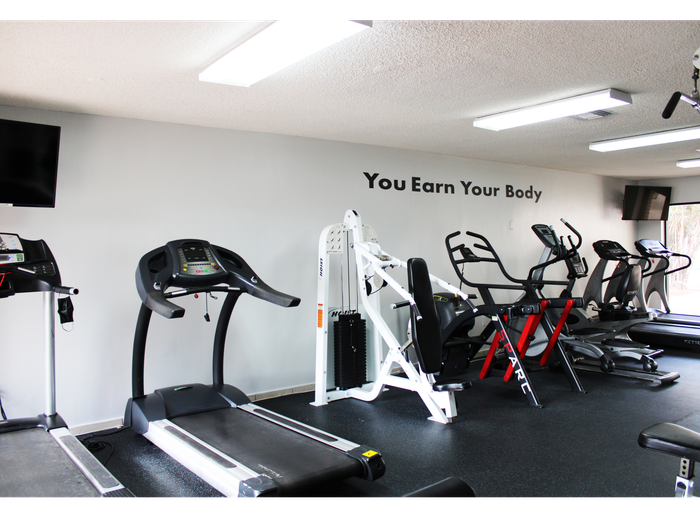 Westland 49 Apartments Interior | Fitness Center |  Treadmills | Workout equipment | Sliding glass door