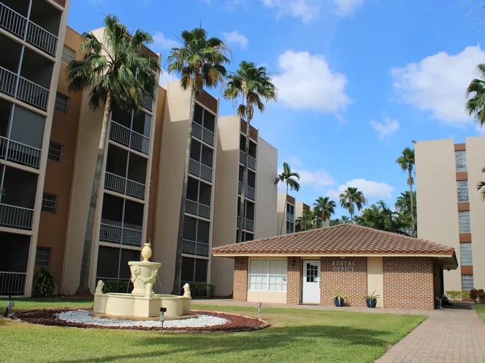 Westland 49 Apartments Exterior | Fountain on grass | 5 story building | Small 1-story building beside it