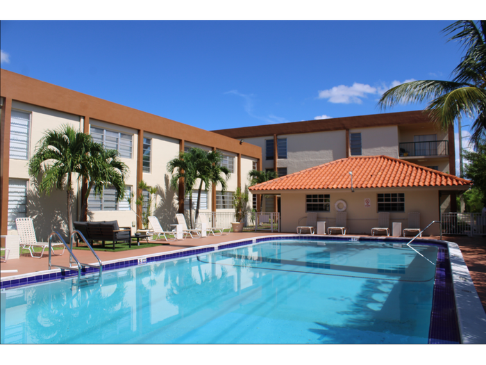 Las Brisas Gardens Apartments, exterior, sparkling blue pool, lounge chairs