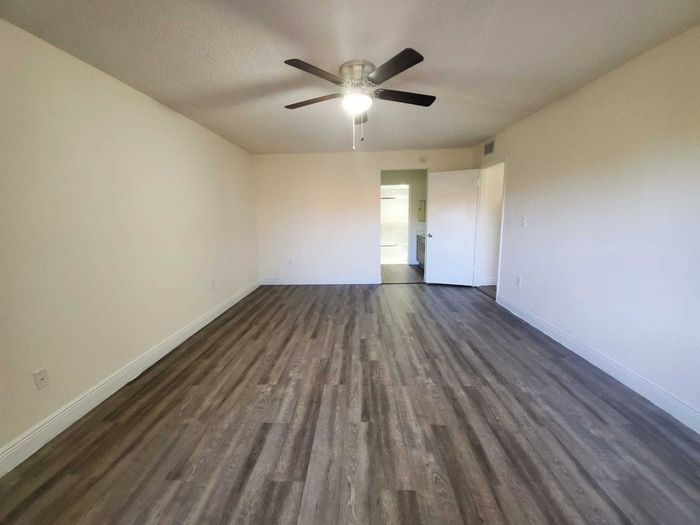 Country Club Towers, interior, spacious open floor plan, dining room, white tile floor, living room, carpeted, large sliding glass doors to outside
