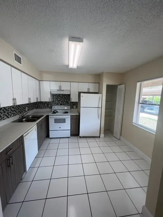 Kitchen with Quartz Countertops and Tiled Flooring