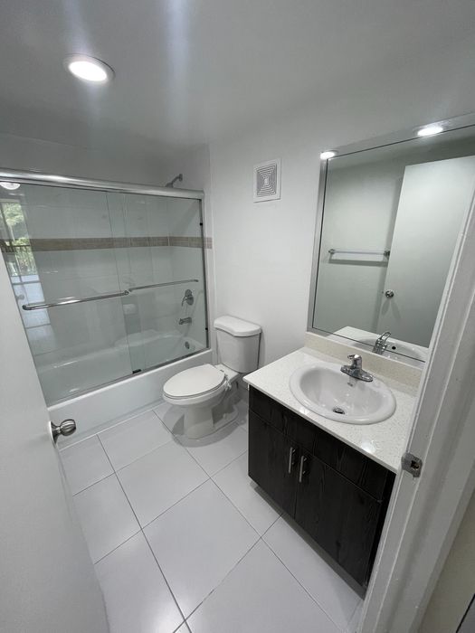 Spacious Bathrooms with Sliding Glass Tub/Shower Doors