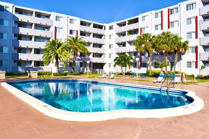 Suncoast Place Apartments- resort style pool- beautiful landscaping- sunny day