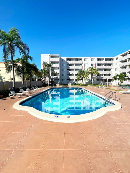 Suncoast Place Apartments- resort style pool- beautiful landscaping- sunny day
