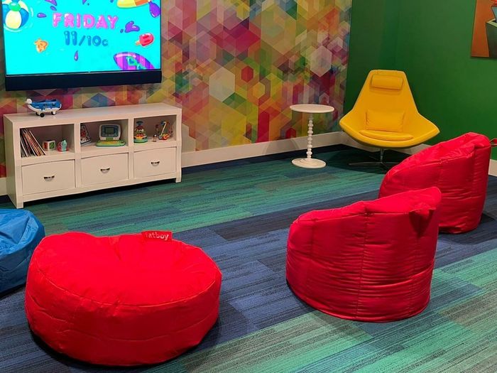 Kids Playroom with multiple bean bag chairs and a tv on the wall
