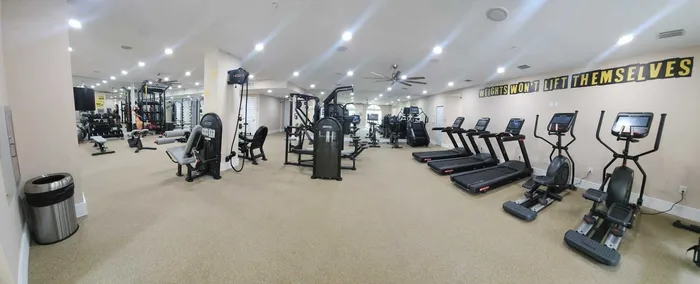 Colony at Dadeland Interior | Fitness center | Several pieces of equipment | Mirror covering wall