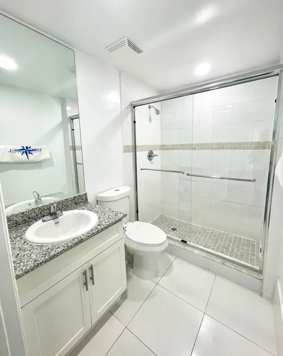 Bathroom with Granite Countertops and Shower with Glass Enclosure