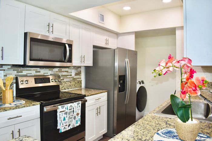 Kitchen with Stainless Steel Appliances & Designer Glass Backsplash Tile