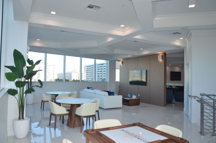 Luxurious open-concept living space with large windows, modern furniture, and stylish decor.
