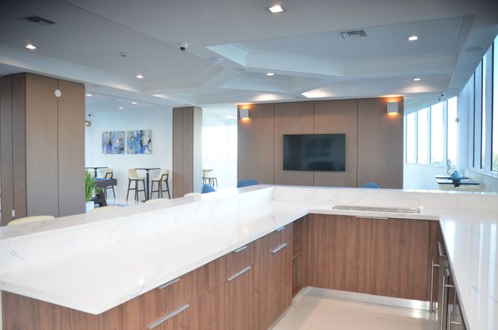 Open-concept kitchen with elegant marble countertops and a cozy lounge area with modern decor.