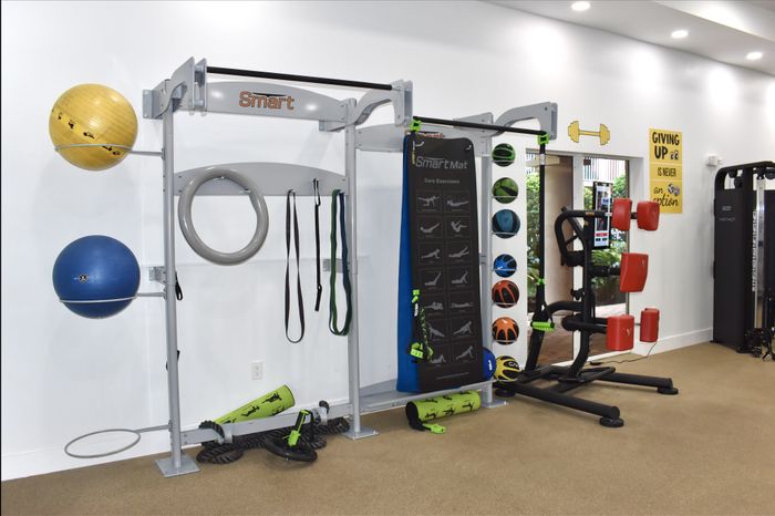 State-of-the-art home gym featuring exercise equipment, resistance bands, and balance balls.