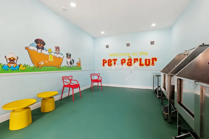 Charming pet parlor with playful wall art, vibrant red chairs, and cheerful yellow tables, perfect for pampering furry friends.