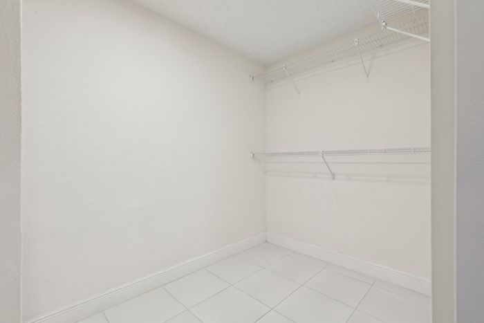 Spacious walk-in closet with sleek wire shelving, perfect for organizing and maximizing storage space.