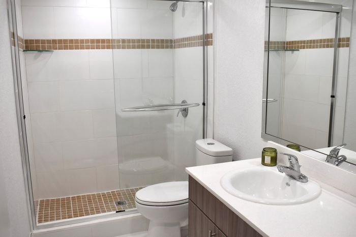 Contemporary bathroom featuring a sleek glass-enclosed shower, modern sink, and elegant fixtures, creating a spa-like retreat.