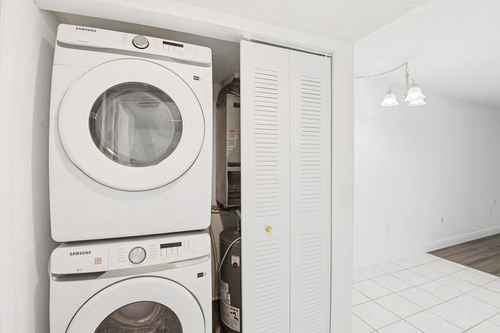 Modern apartment featuring a sleek Samsung washer and dryer set in a bright, tiled laundry area.