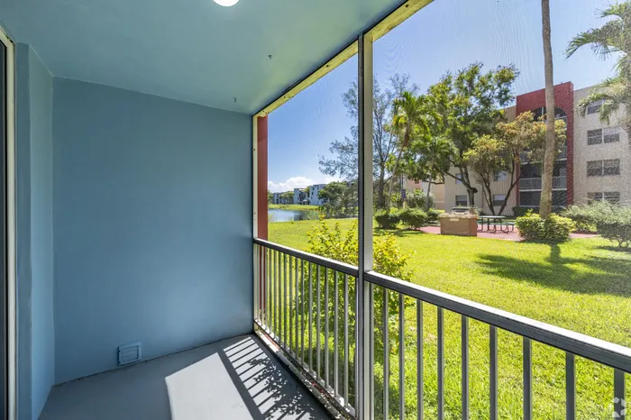 Charming balcony with a serene view of lush green gardens, perfect for relaxation and enjoying the outdoors.