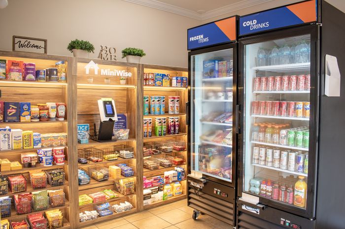 Charming in-store display showcasing an array of snacks, frozen items, and cold drinks at MiniWise, offering convenience and variety in a welcoming setting.