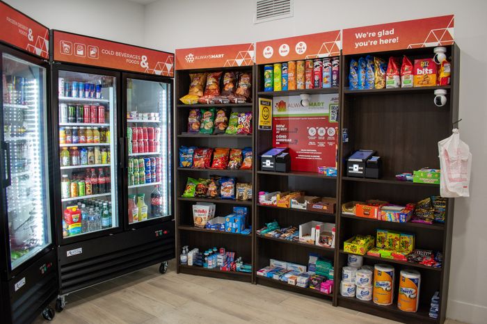 Chic in-building convenience store offering a variety of snacks, drinks, and daily essentials with bright, modern shelving.