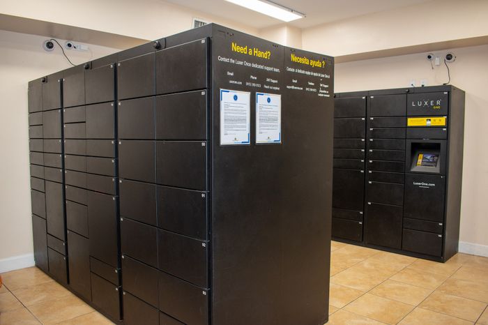 Modern parcel locker system with secure compartments and user-friendly interface in an apartment building.