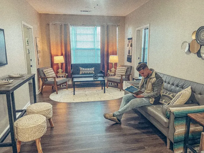the view apartments man in apartment reading a book