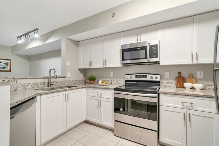 Modern kitchen with sleek appliances, granite countertops, and elegant cabinetry, offering a stylish and functional culinary space.