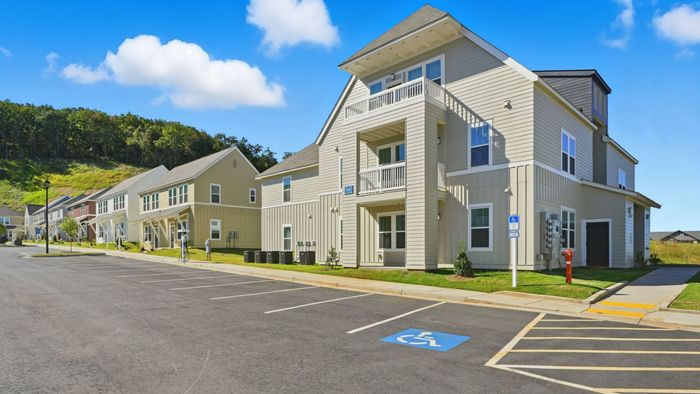 Charming townhouse community nestled in a scenic landscape, featuring modern architecture and spacious balconies, perfect for relaxed living.