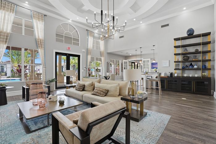 Elegant apartment lounge showcasing stylish decor, modern furniture, and ample natural light, ideal for comfortable living.