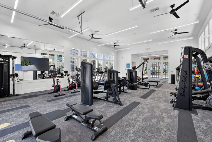 Bright and modern fitness center with state-of-the-art exercise equipment and ample natural light.